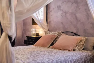 a bedroom with a bed with pillows on it at Riad Medina Mudéjar Cádiz in Chiclana de la Frontera