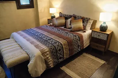 a bedroom with a large bed with pillows on it at Riad Medina Mudéjar Cádiz in Chiclana de la Frontera