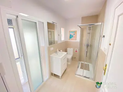 a bathroom with a shower and a toilet and a sink at Gades Natura Victoria Beach in Cádiz
