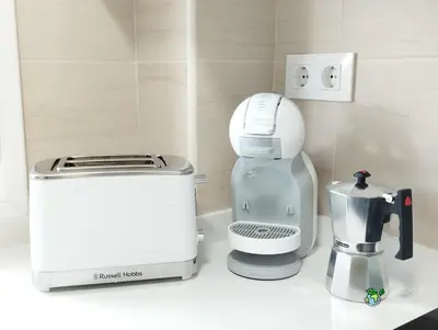 a kitchen counter with a coffee maker and a toaster at Gades Natura Victoria Beach in Cádiz
