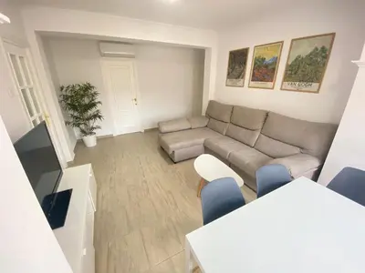 a living room with a couch and a table at Gades Natura Victoria Beach in Cádiz