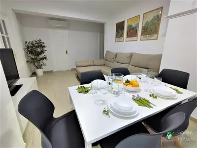 a white table and chairs in a living room at Gades Natura Victoria Beach in Cádiz
