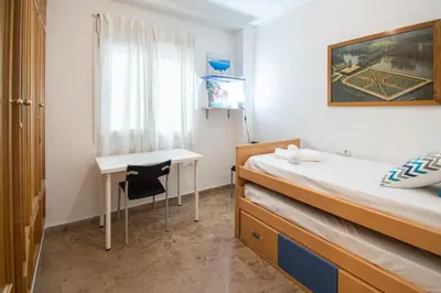 a small room with a bed and a desk at Apartamento El Anteojo de Cádiz in Cádiz