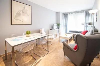 a living room with a table and chairs at Apartamento El Anteojo de Cádiz in Cádiz