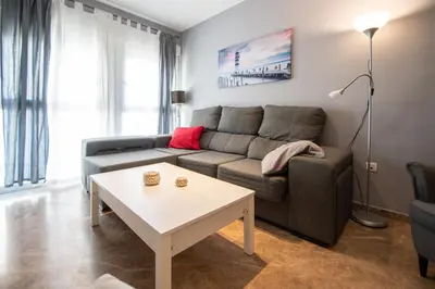a living room with a couch and a table at Apartamento El Anteojo de Cádiz in Cádiz