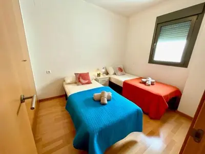 a room with two beds with a teddy bear sitting on them at GATU PREMIUM Marismas, terraza, parking, piscina común y aire acc , 