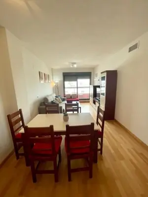 a kitchen and dining room with a table and chairs at GATU PREMIUM Marismas, terraza, parking, piscina común y aire acc , 
