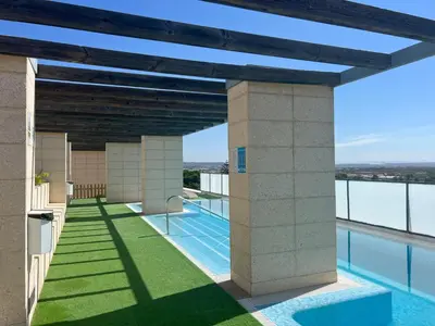 a view of the pool from the balcony of a building at GATU PREMIUM Marismas, terraza, parking, piscina común y aire acc , 