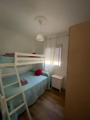 a bedroom with a bunk bed and a ladder at Chalet Brisas del Mar in Chiclana de la Frontera