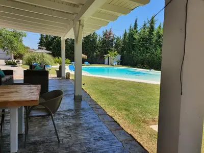 a patio with a table and chairs and a pool at Chalet Brisas del Mar in Chiclana de la Frontera
