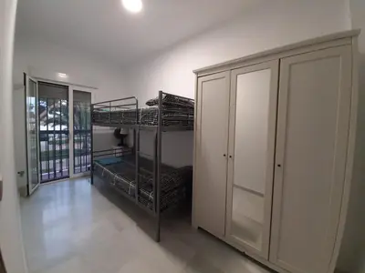 a room with two bunk beds and a closet at Villa Puerto Santa María in El Puerto de Santa María