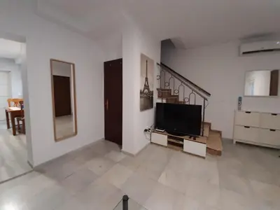 a living room with a flat screen tv on a wall at Villa Puerto Santa María in El Puerto de Santa María