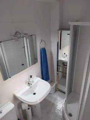 a white bathroom with a sink and a shower at Villa Puerto Santa María in El Puerto de Santa María