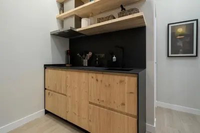 a kitchen with a wooden island in a room at Alma Playa la Caleta Grupo AC Gestion in Cádiz