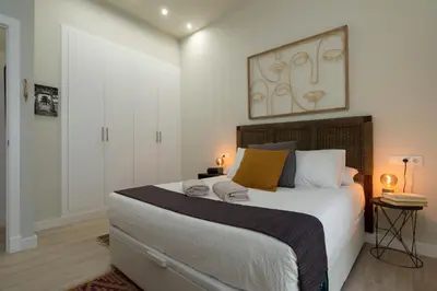 a bedroom with a large bed in a room at Alma Playa la Caleta Grupo AC Gestion in Cádiz