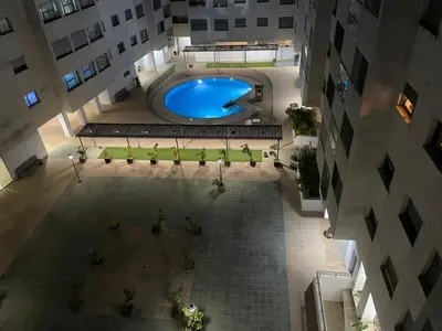 an overhead view of a building with a swimming pool at EL ATICO DE MARIA con garaje, piscina y terraza in El Puerto de Santa María