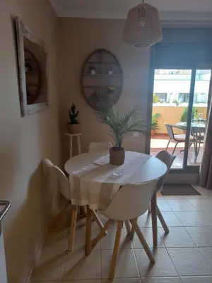a plate with a pink rose on a table at EL ATICO DE MARIA con garaje, piscina y terraza in El Puerto de Santa María