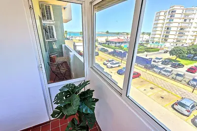 a window with a view of a parking lot at Ocean View Beach Apartment with Pool & Balconies in El Puerto de Santa María
