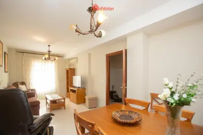 a living room with a table and a couch at El Anfitrión - Dúplex Doña Ana in Sanlúcar de Barrameda