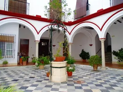 a courtyard with potted plants in a building at ACOGEDOR APARTAMENTO EN SANLUCAR DE BARRAMEDA in Sanlúcar de Barrameda