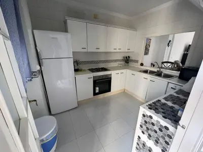a kitchen with a white refrigerator and a sink at CASA RAUSER in Chipiona