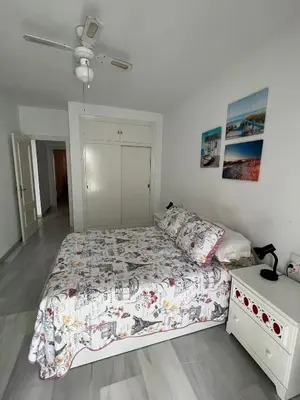 a bedroom with a bed and a dresser in it at CASA RAUSER in Chipiona