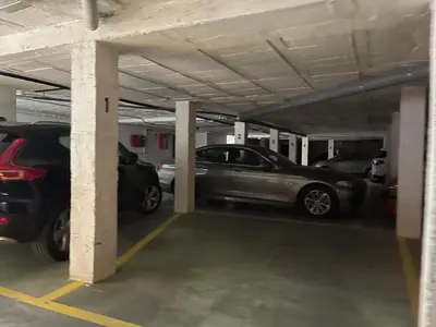 a parking garage with cars parked in it at CASA RAUSER in Chipiona