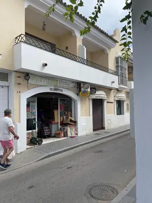 a man walking in front of a store on a street at CASA RAUSER in Chipiona