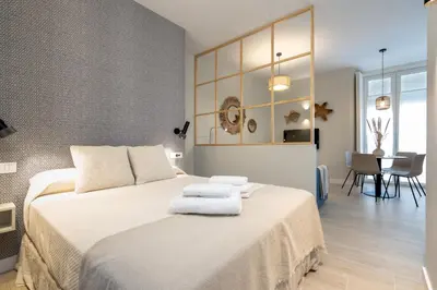 a bedroom with a large bed with two towels on it at Suit 42 Playa y Ascensor Grupo AC Gestion in Cádiz