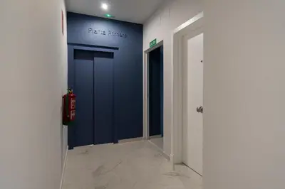 a hallway with a blue door in a room at Suit 42 Playa y Ascensor Grupo AC Gestion in Cádiz