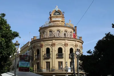 a building with a clock on the top of it at Sherryflat Alma in Jerez de la Frontera