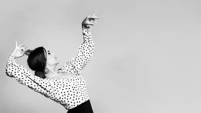 a woman is dancing with her arms in the air at Sherryflat Alma in Jerez de la Frontera