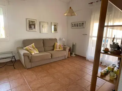 a living room with a couch and a table at Ático Amaranta in Chiclana de la Frontera
