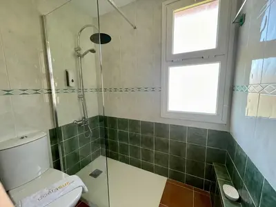 a bathroom with a shower and a toilet at Ático Amaranta in Chiclana de la Frontera