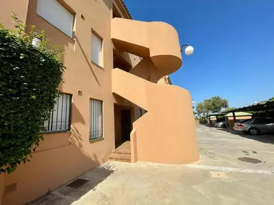 a building with a spiral staircase on the side of it at Ático Amaranta in Chiclana de la Frontera
