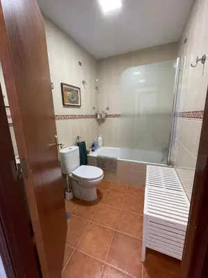 a bathroom with a toilet and a bath tub at Luz de la Caleta in Cádiz
