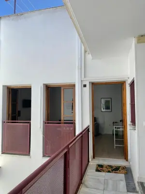 a view from the balcony of a white building with a corridor at Luz de la Caleta in Cádiz