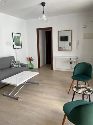 a living room with a couch and chairs and a table at Luz de la Caleta in Cádiz