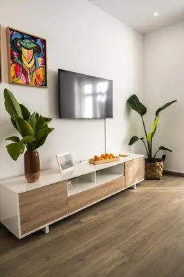 a living room with a tv on a white wall at Prim 14 by 7Escalones in Rota