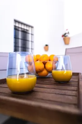 two glasses of orange juice and oranges on a table at Prim 14 by 7Escalones in Rota