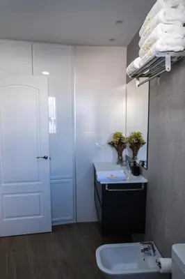 a bathroom with a sink and a white door at Prim 14 by 7Escalones in Rota