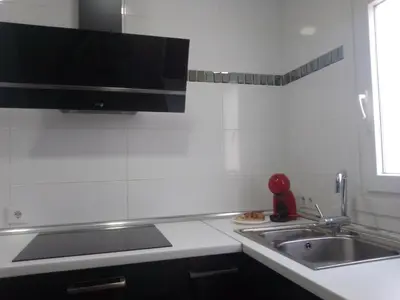 a kitchen with a sink and a counter top at White relax house for 6 - Pool & Spa privé in Chiclana de la Frontera