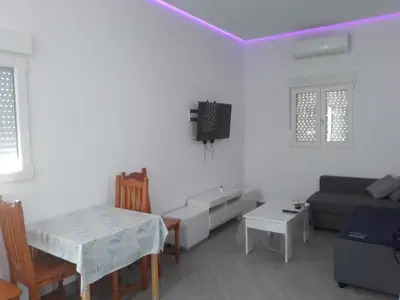 a living room with a couch and a table at White relax house for 6 - Pool & Spa privé in Chiclana de la Frontera