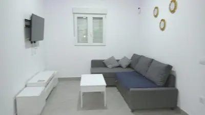 a living room with a couch and a table at White relax house for 6 - Pool & Spa privé in Chiclana de la Frontera