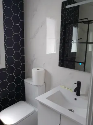 a bathroom with a white toilet and a sink at White relax house for 6 - Pool & Spa privé in Chiclana de la Frontera