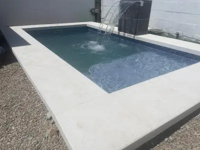 a pool with a water fountain in a house at White relax house for 6 - Pool & Spa privé in Chiclana de la Frontera