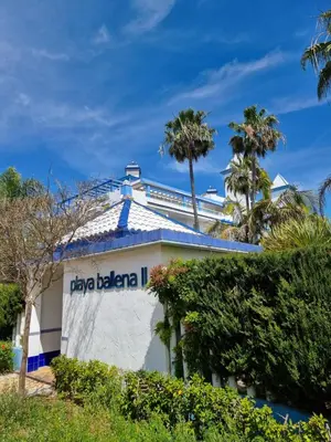 a building with the sign for la bella bella ii at Ático en Costa Ballena con Barbacoa, Aire Acondicionado y WIFI in Costa Ballena