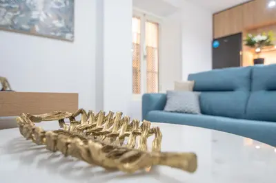 a gold saxophone sitting on a table in a living room at Apartamento La Magnolia de Cádiz in Cádiz