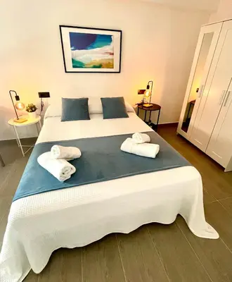a bedroom with a large bed with towels on it at Carmen viejo 12 in Sanlúcar de Barrameda
