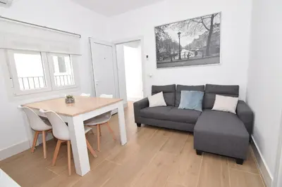 a living room with a couch and a table at Apartamentos Atlantida in Chipiona